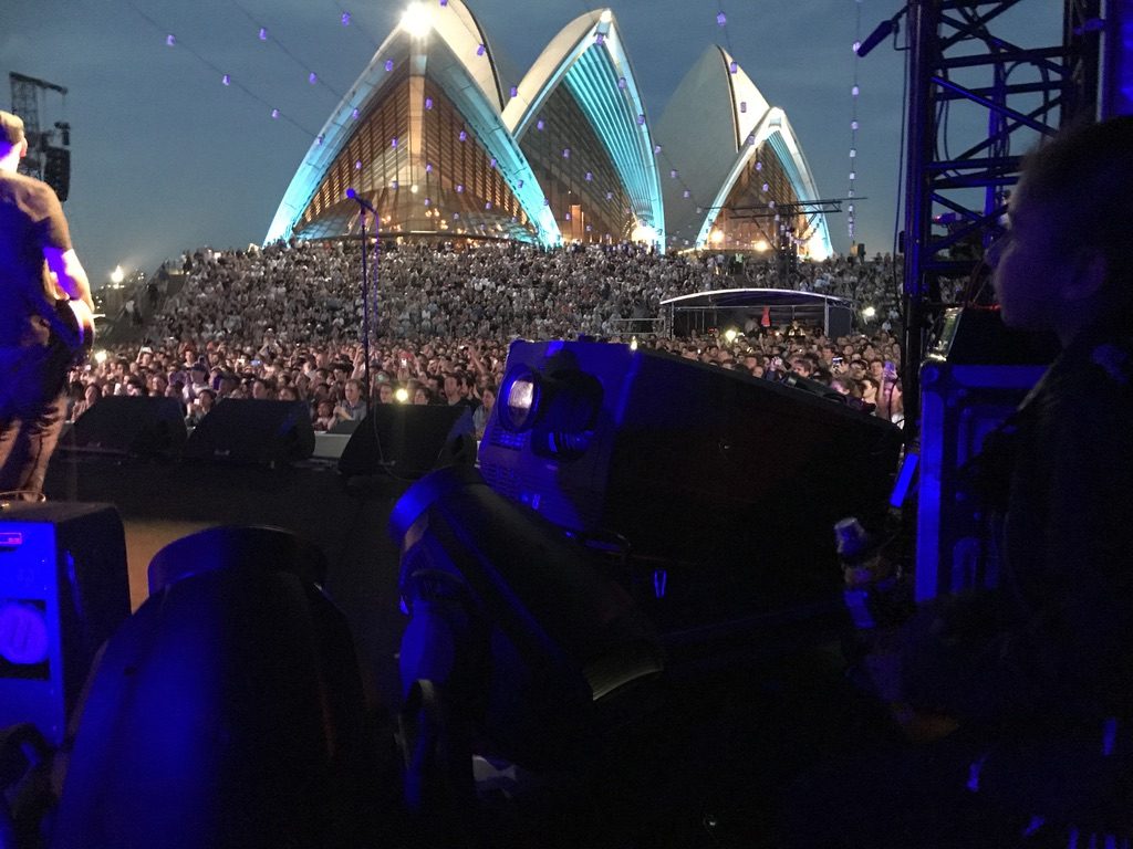 The Opera House sails from side of stage, crowd filling the forecourt
